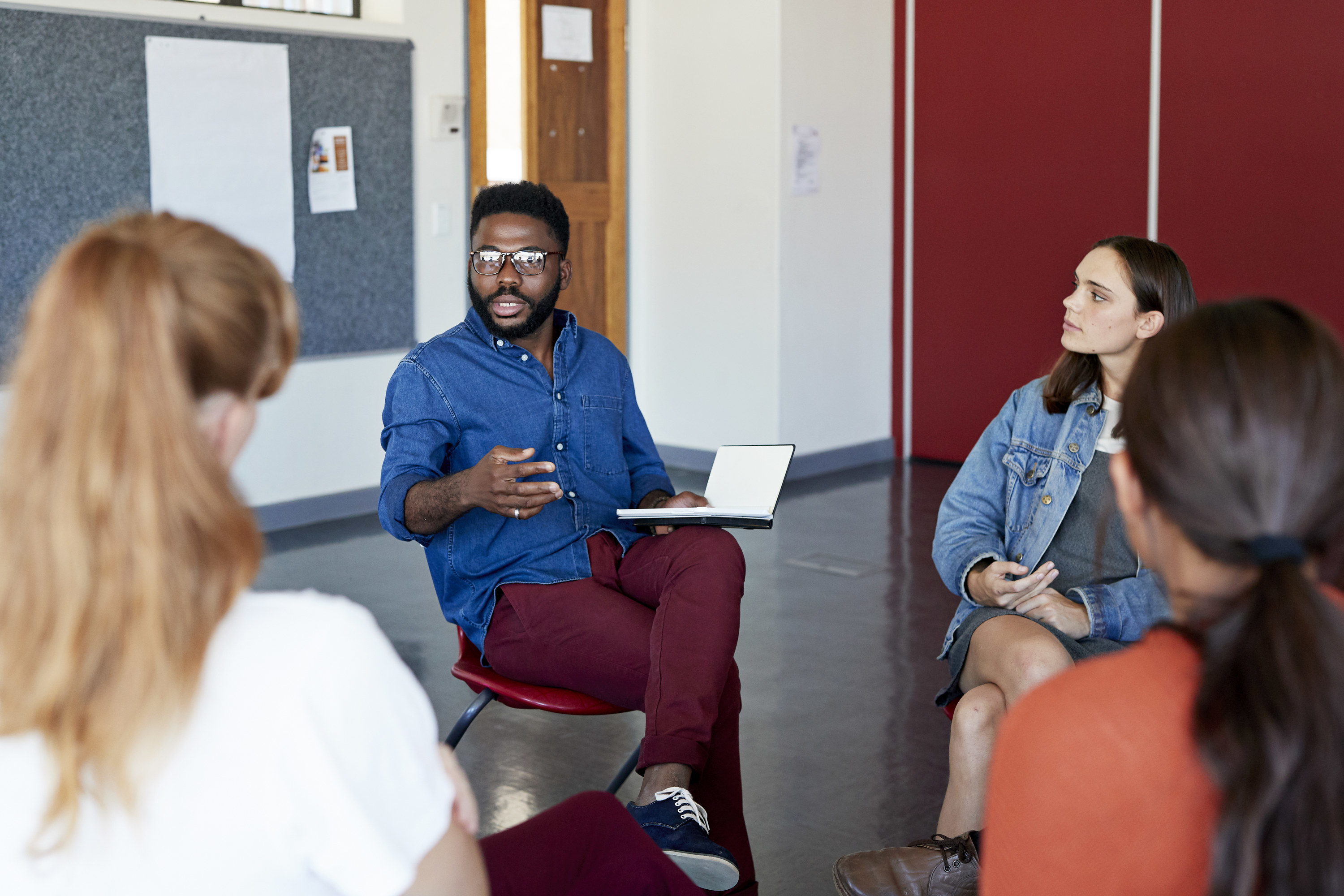 Professor talking with college students in a discussion group