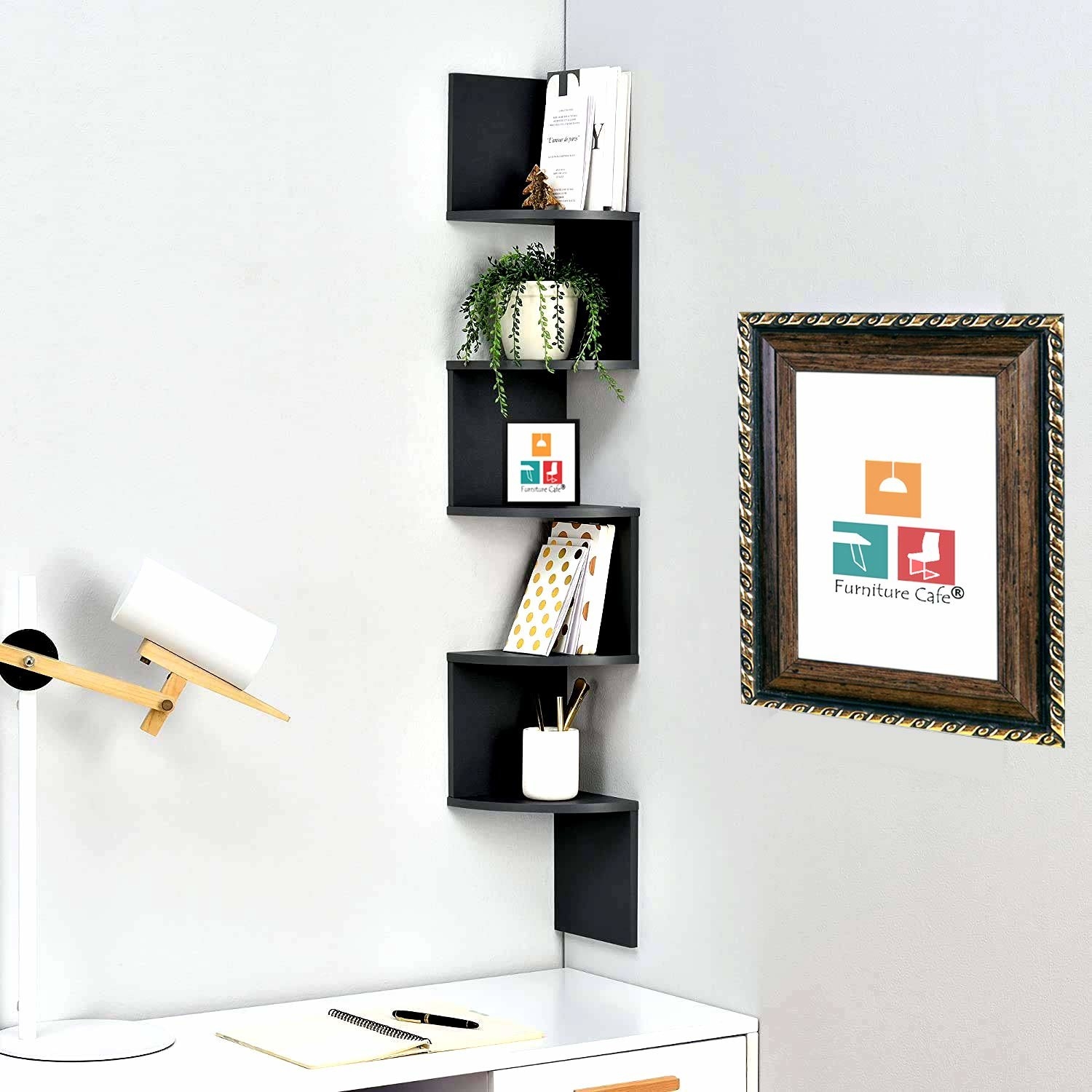 The corner zig-zag shelf with books and other stationery mounted above a desk with a lamp and notebook kept open