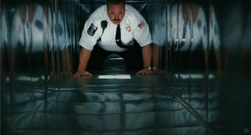Paul Blart crawling through an air vent