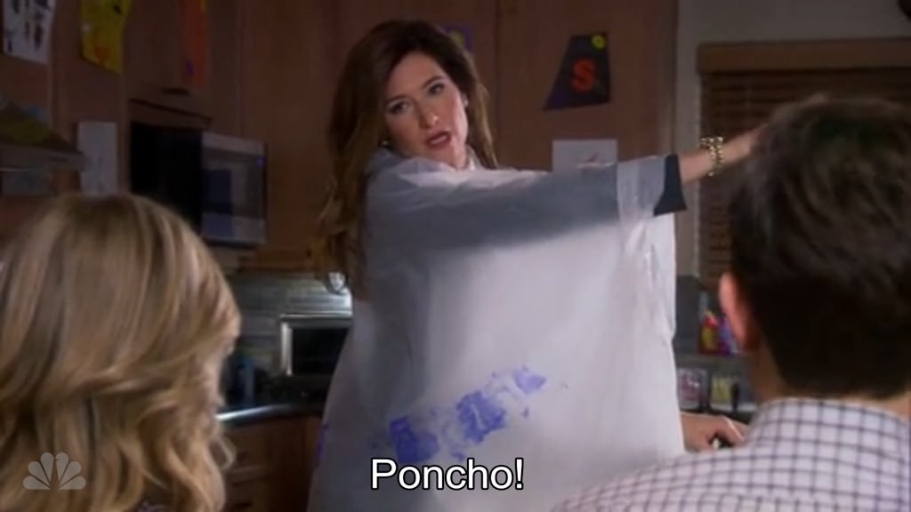 Jennifer showing off her poncho to Ben and Leslie