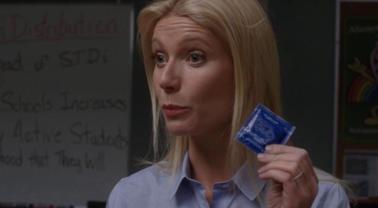 Ms. Holiday holding up a condom for demonstration