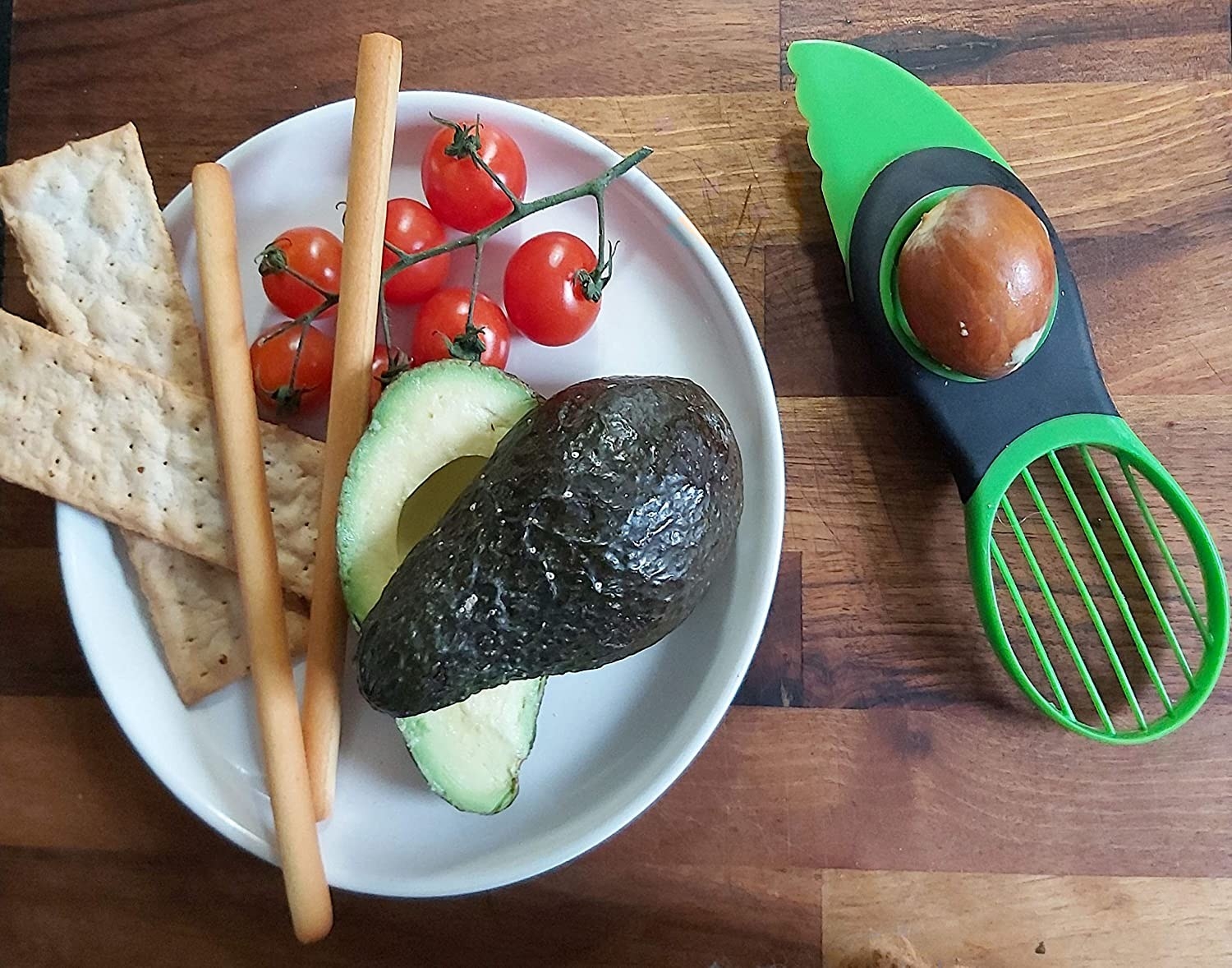 avocado slicer with plate of food