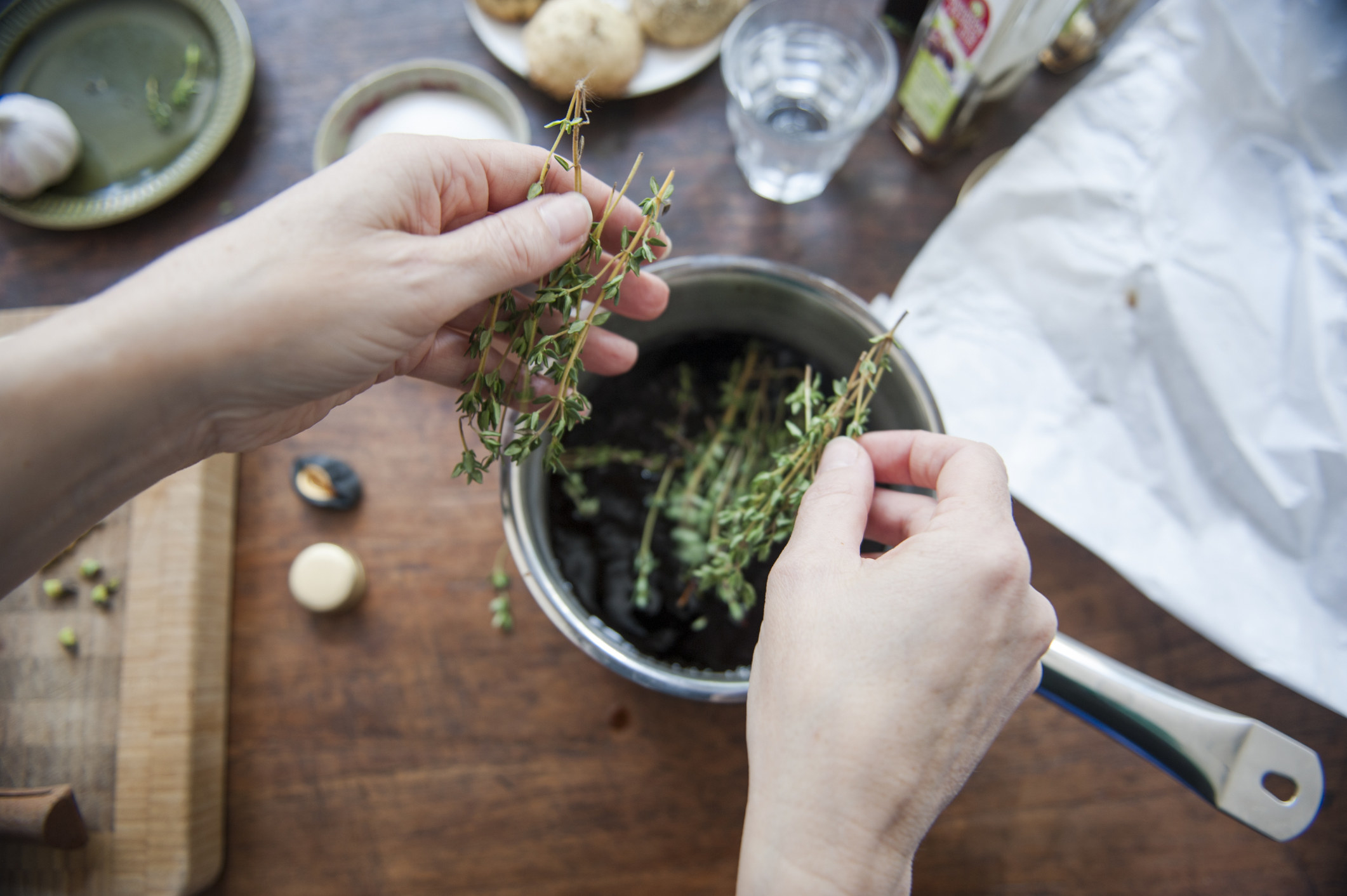 Putting thyme into a bowl.