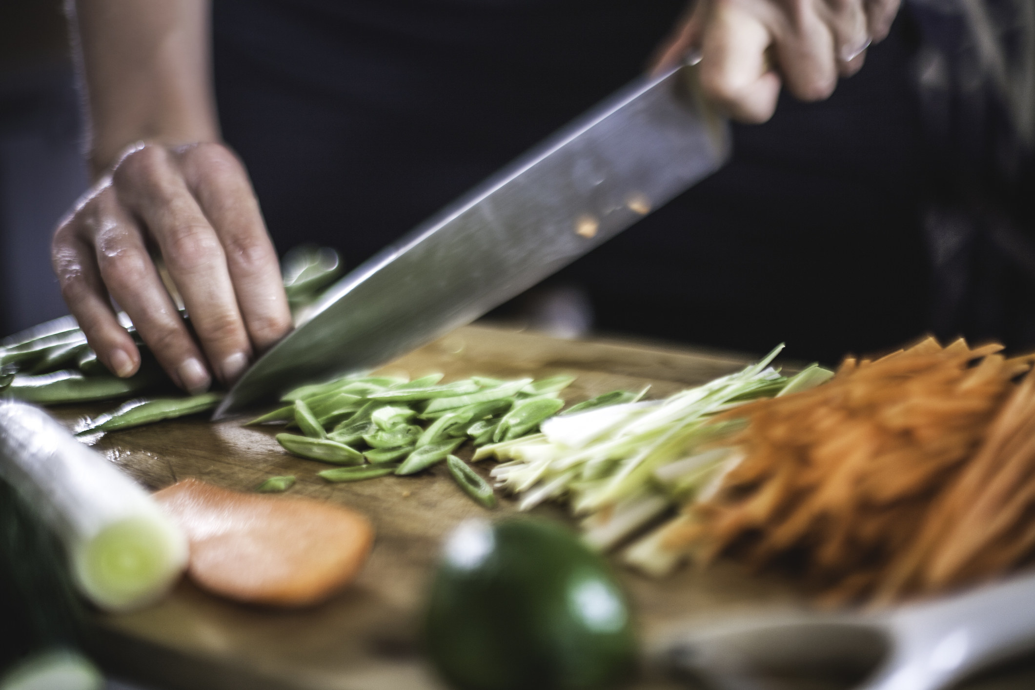 Cutting veggies with a kitchen knife.