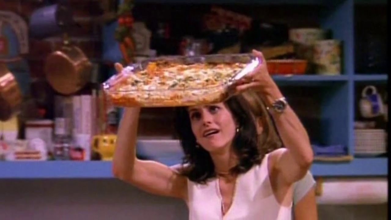 Monica lifting up her lasagna.