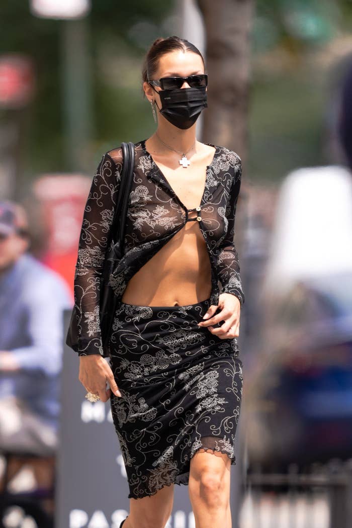 Bella Hadid is pictured wearing a face mask while walking outside in New York City in August 2021