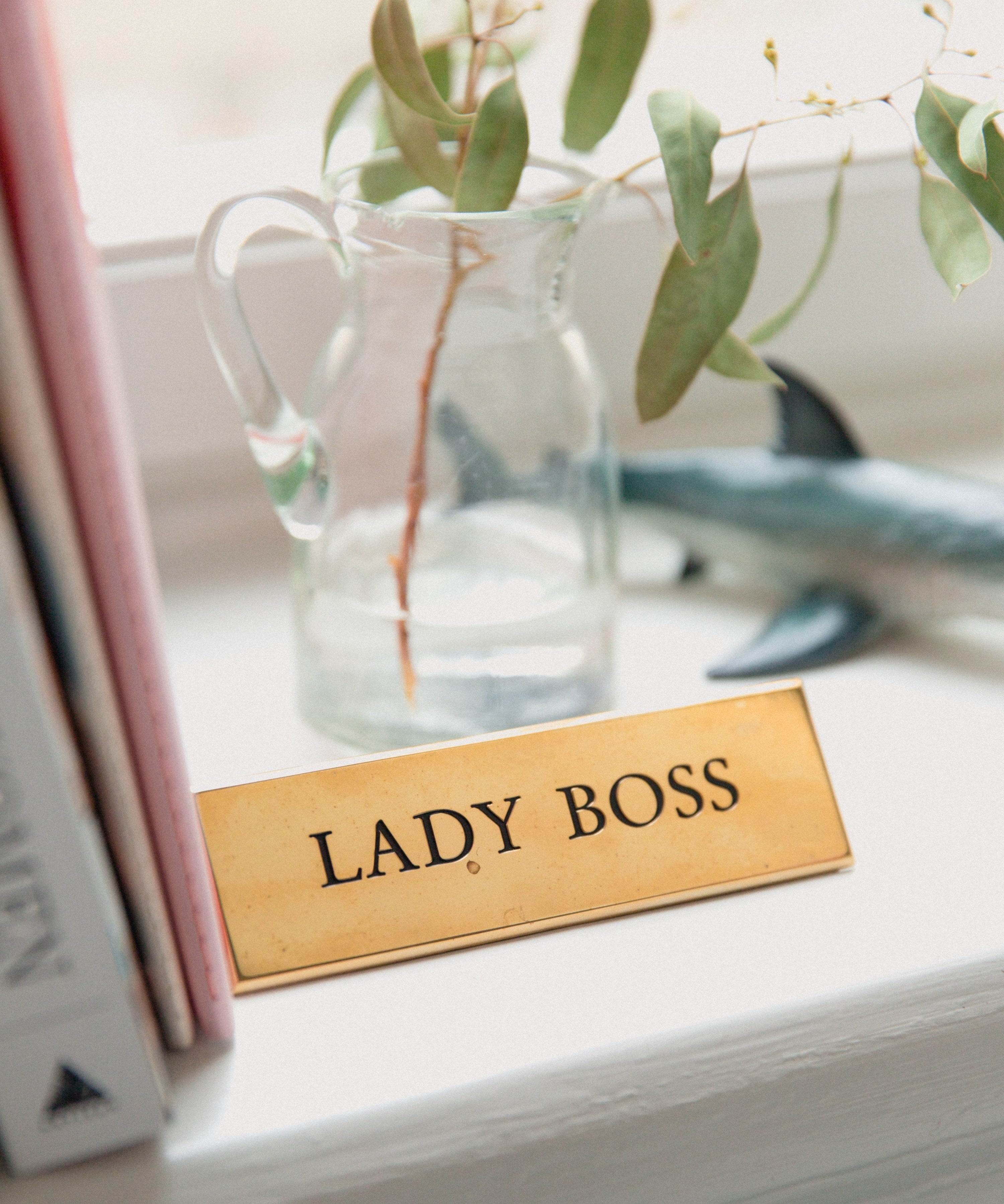 A gold office name tag with the &#x27;lady boss&#x27; phrase.