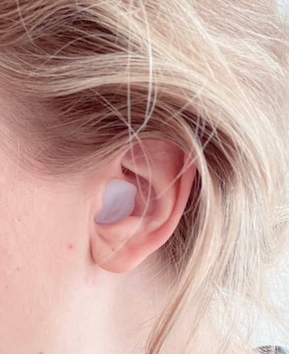 BuzzFeed editor with silicone earplug fitted into ear