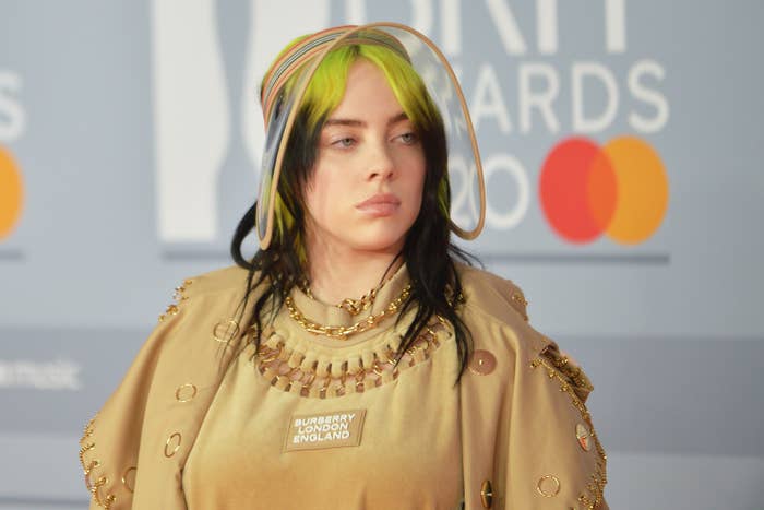 Billie wearing a neutral toned outfit with an oversized visor at the 2020 Brit Awards