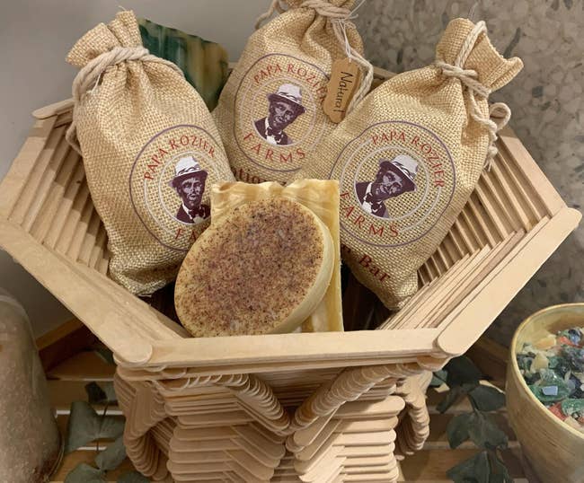 a lotion bar surrounded several others in burlap drawstring packaging