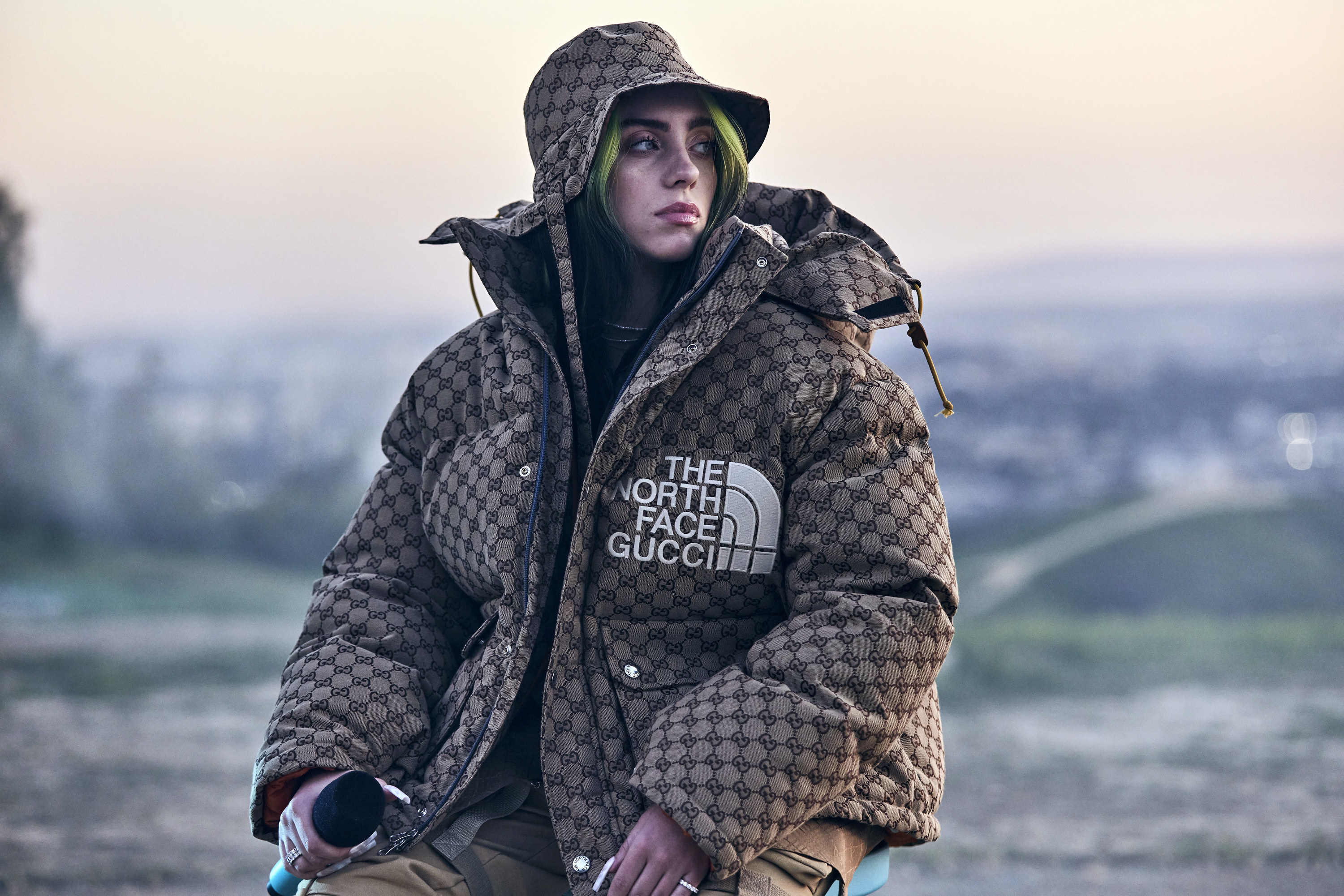 Billie wearing a large North Face puffer jacket with matching bucket hat