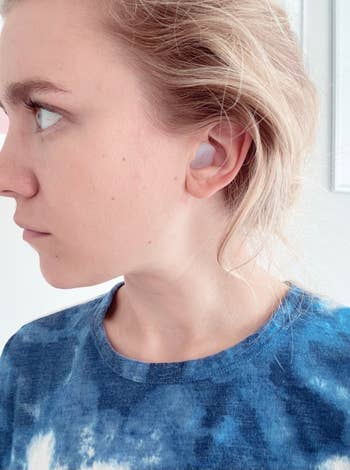 Buzzfeed editor with silicone ear plugs in ear 