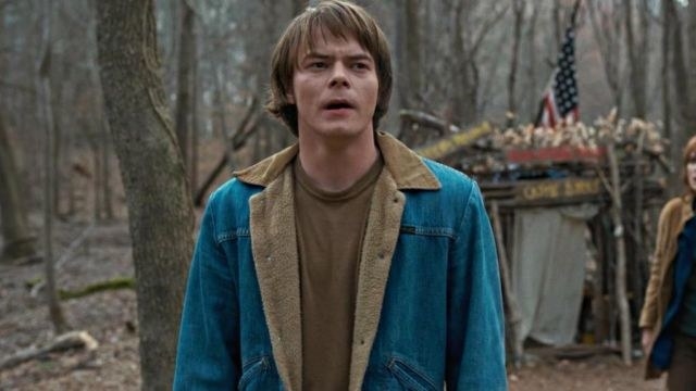Jonathan wearing a jean jacket in the woods.