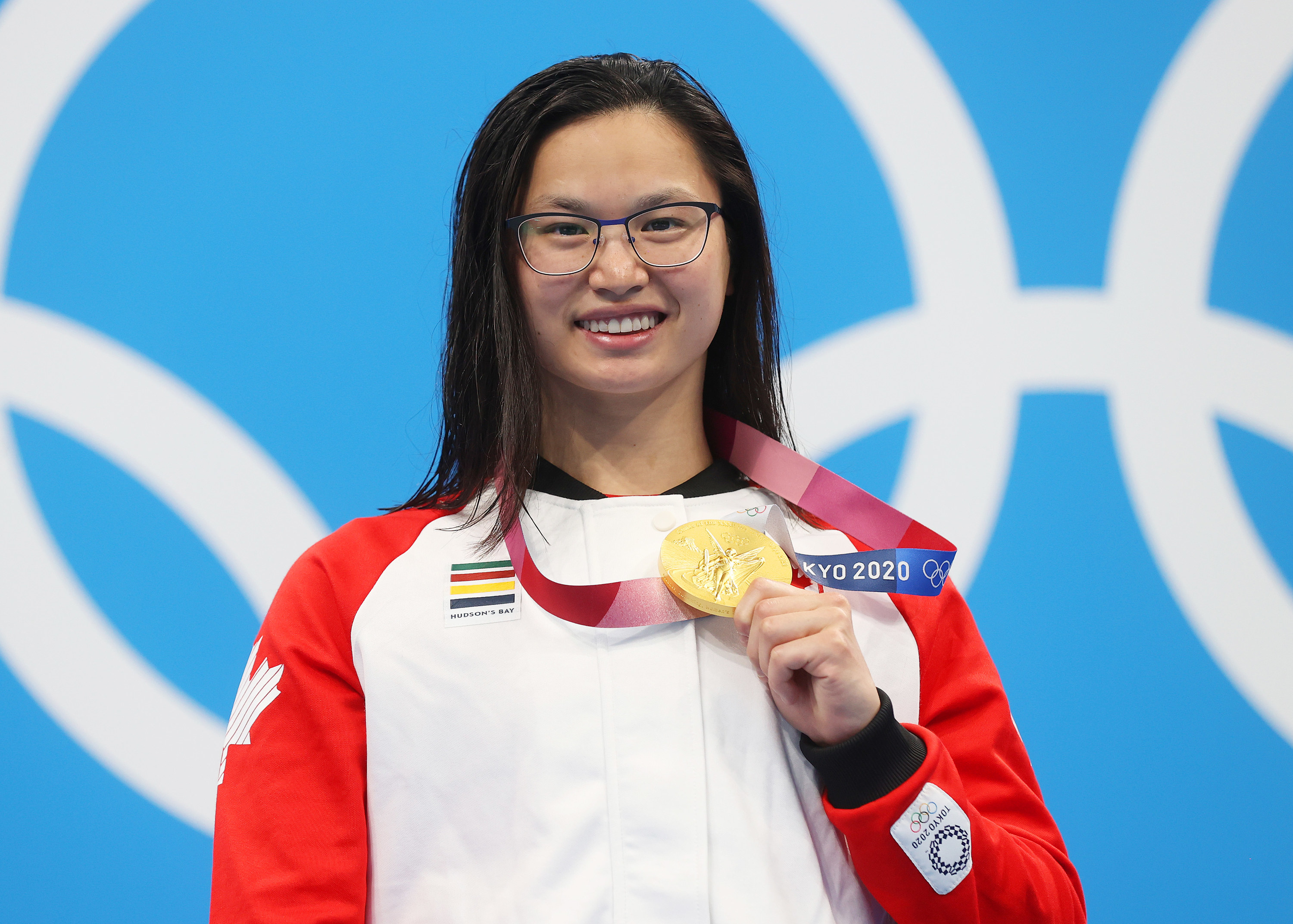 Maggie holding up her medal