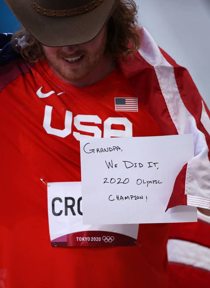 Ryan holds up a sign that says, &quot;Grandpa, We did it, 2020 Olympic Champion!&quot;