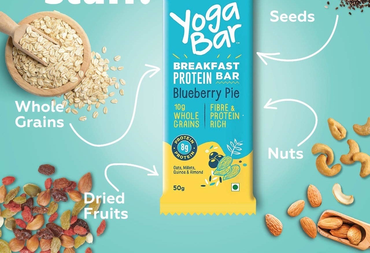 A yoga bar in the flavour blueberry pie with a breakdown of ingredients such as whole grains, dried fruits, nuts and seeds