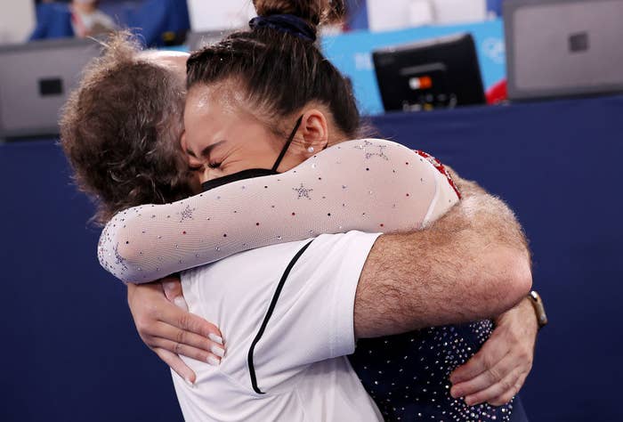 Suni being hugged by a coach