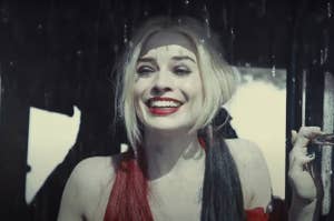 harley quinn smiles, brows raised as if nervous