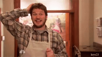 a gif of andy from parks and rec looking concerned and apologetic