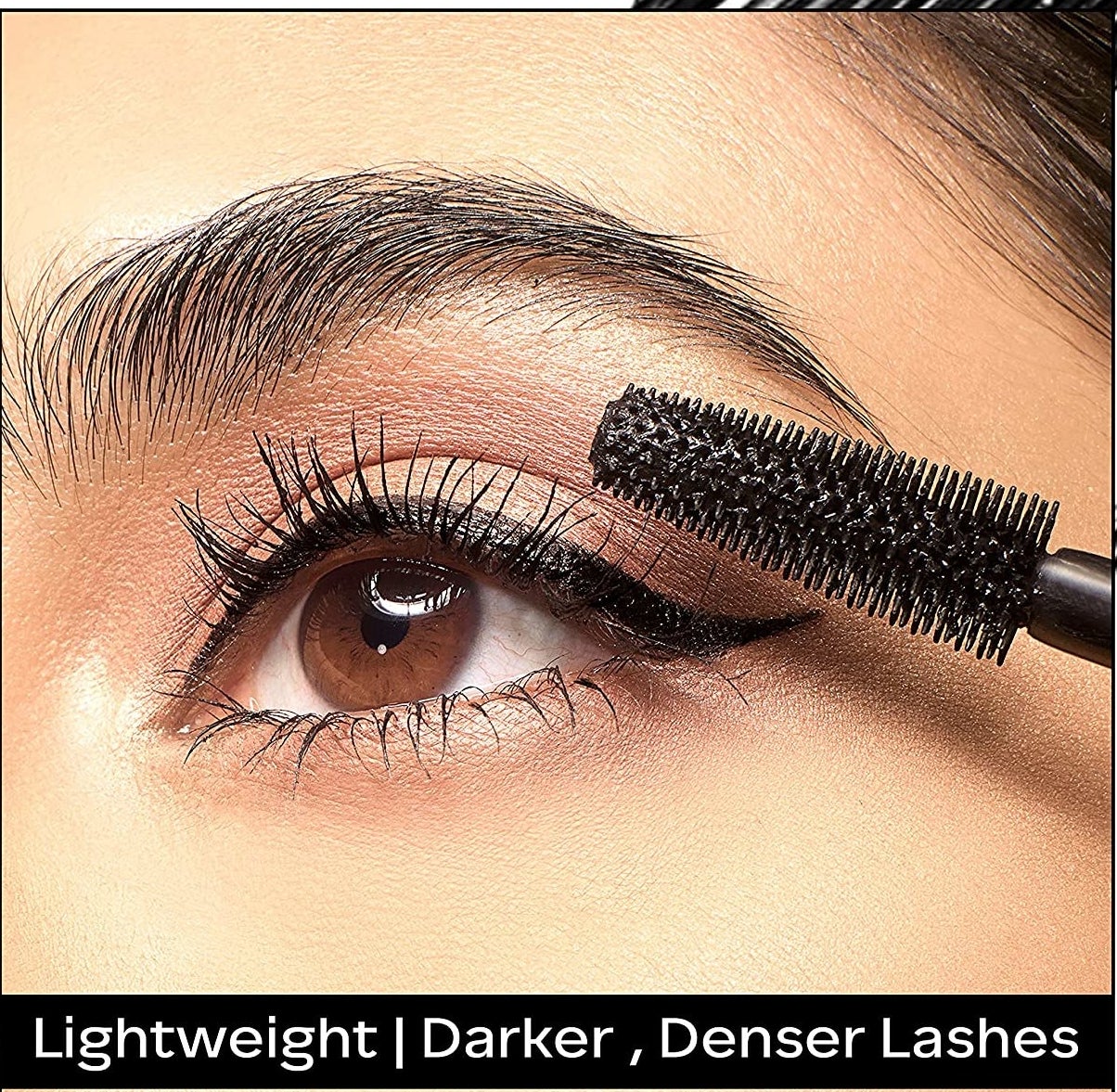 A person putting mascara on their lashes