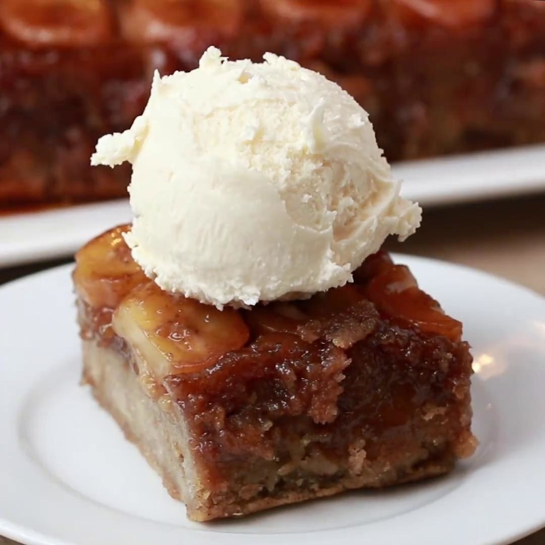 A square section of caramelized banana bread with a single scoop of vanilla ice cream on top