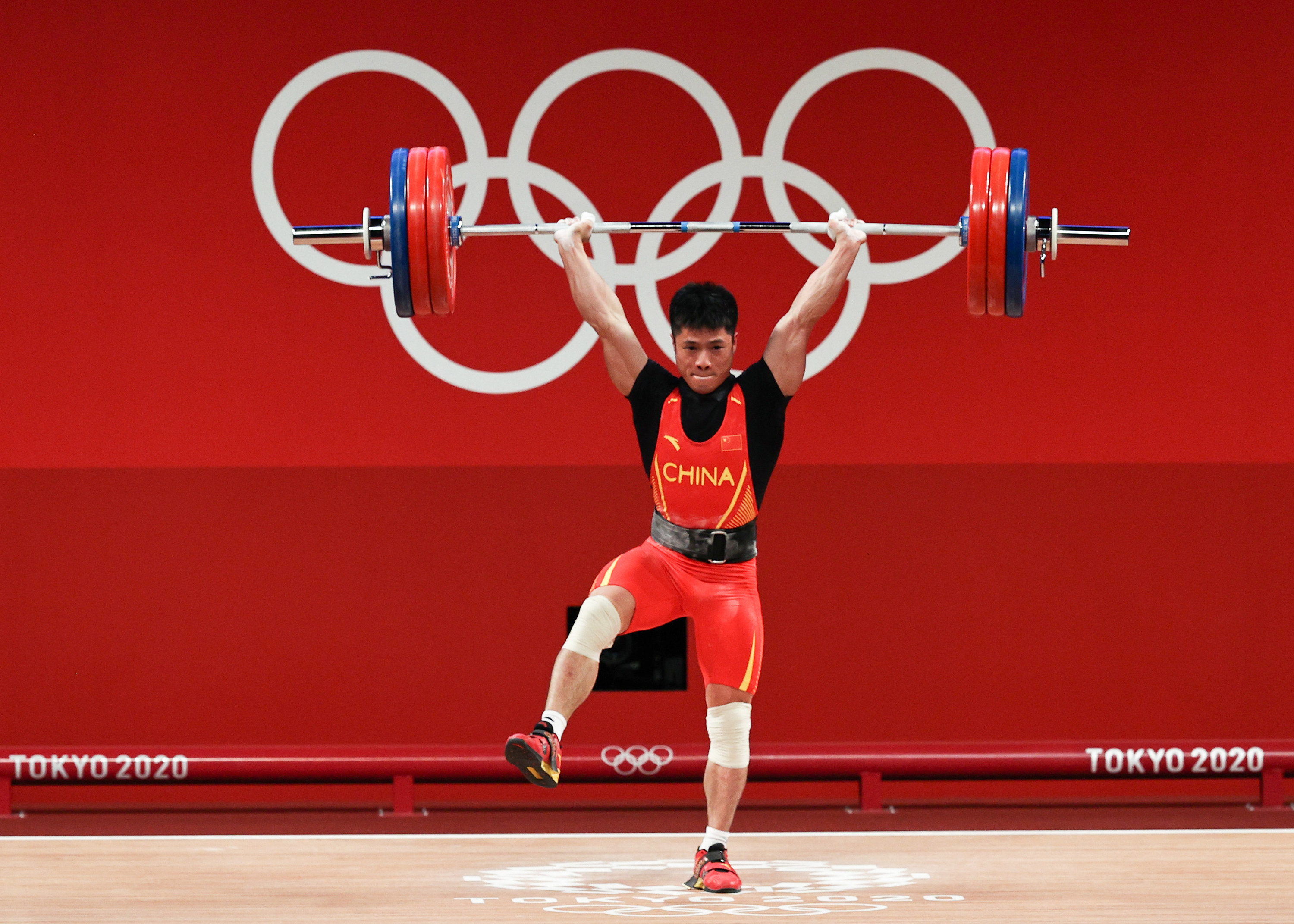 Li lifts as he stands on one leg