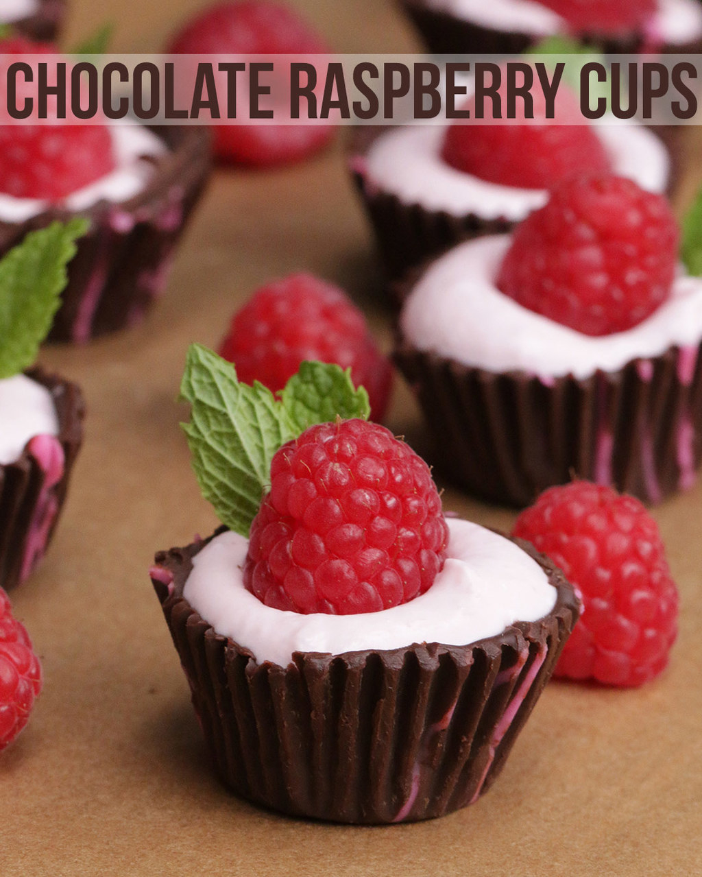 Mini chocolate cups filled with vanilla icing and a raspberry