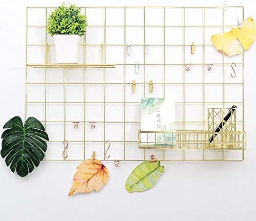 A gold, rectangular steel grid with pins and shelves filled with stationery items