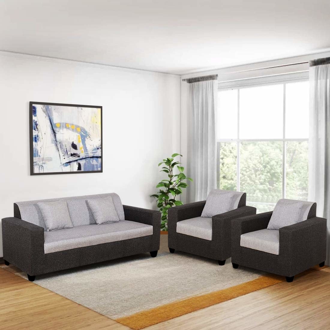 A two-seater sofa next to two sofa chairs