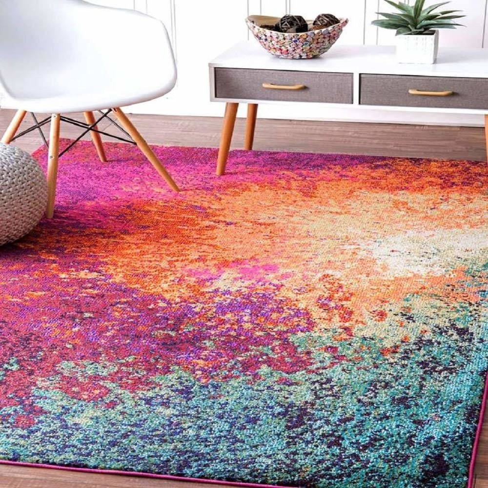 The multicolour carpet placed under a coffee table, chair and pouffe.