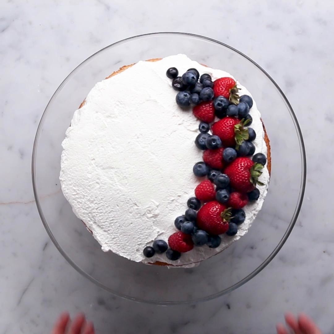 Mexican dessert with topped full of whipped cream and a variety of berries including blueberries, strawberries and raspberries