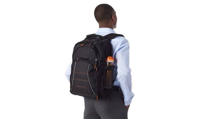 A man wearing a laptop bag on his back