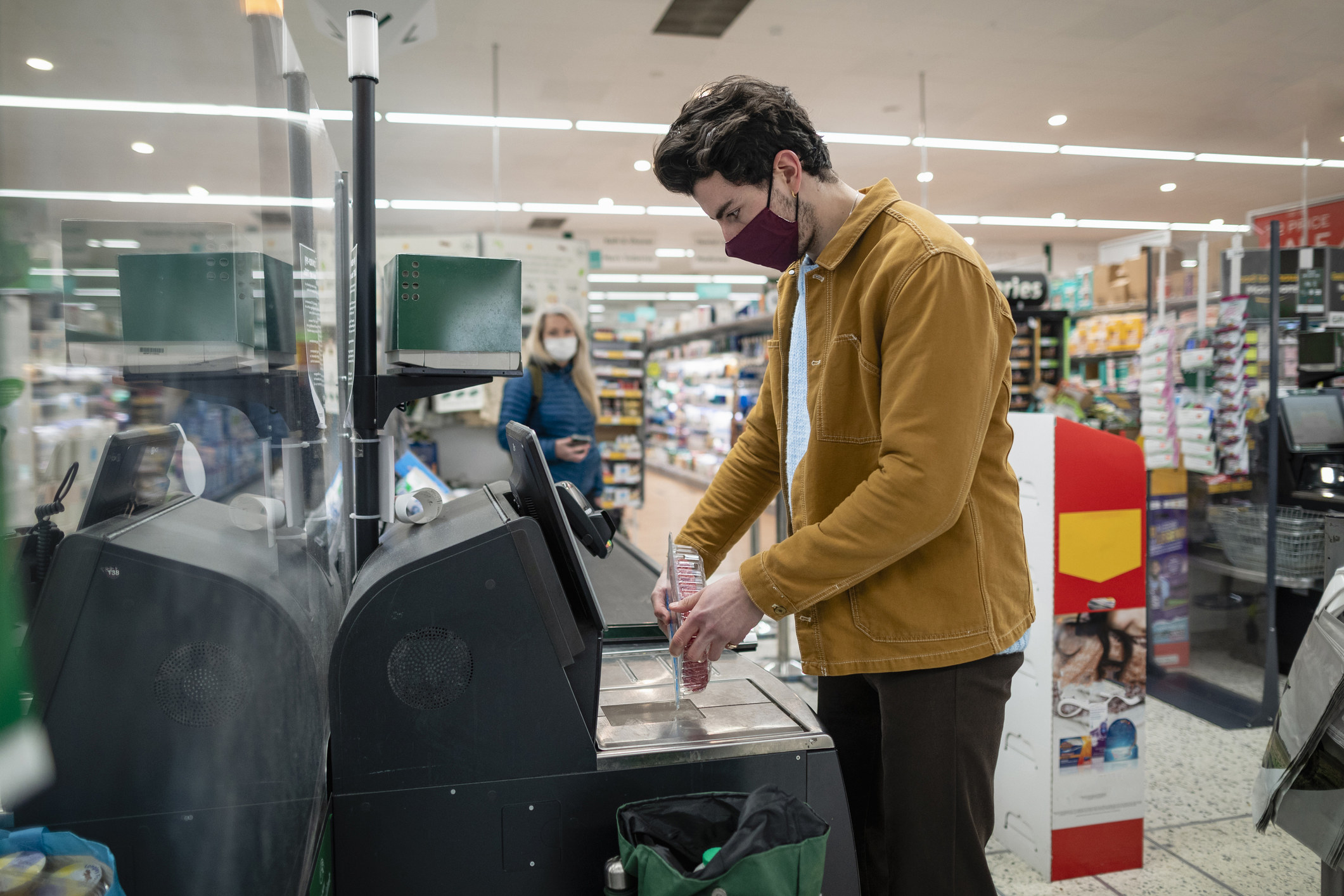 A person scanning an item in the self-checkout line