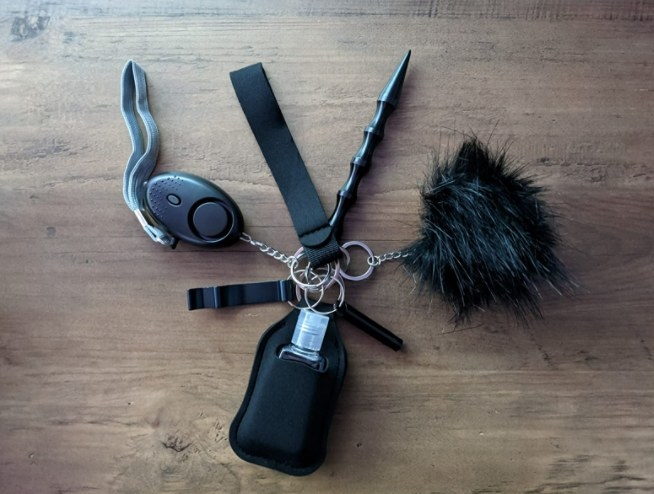 the keychain with alarm, glass breaker, bottle opener, hand sanitizer and poof