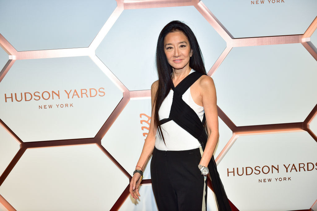 Vera Wang wears a white tee with a wrapped black flowing scarf and black pants to the Hudson Yards Grand Opening Party