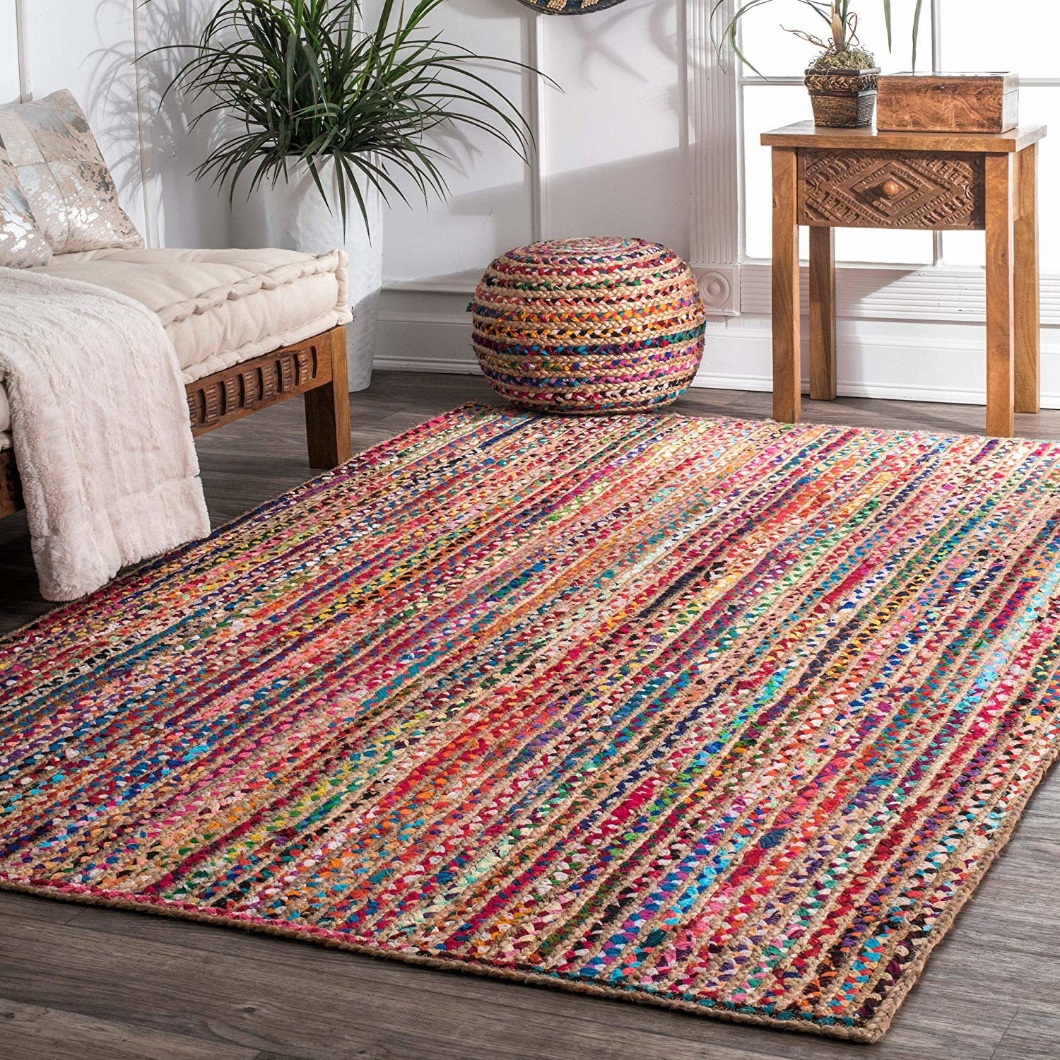 A colourful braided rug with jute and cotton placed on the floor