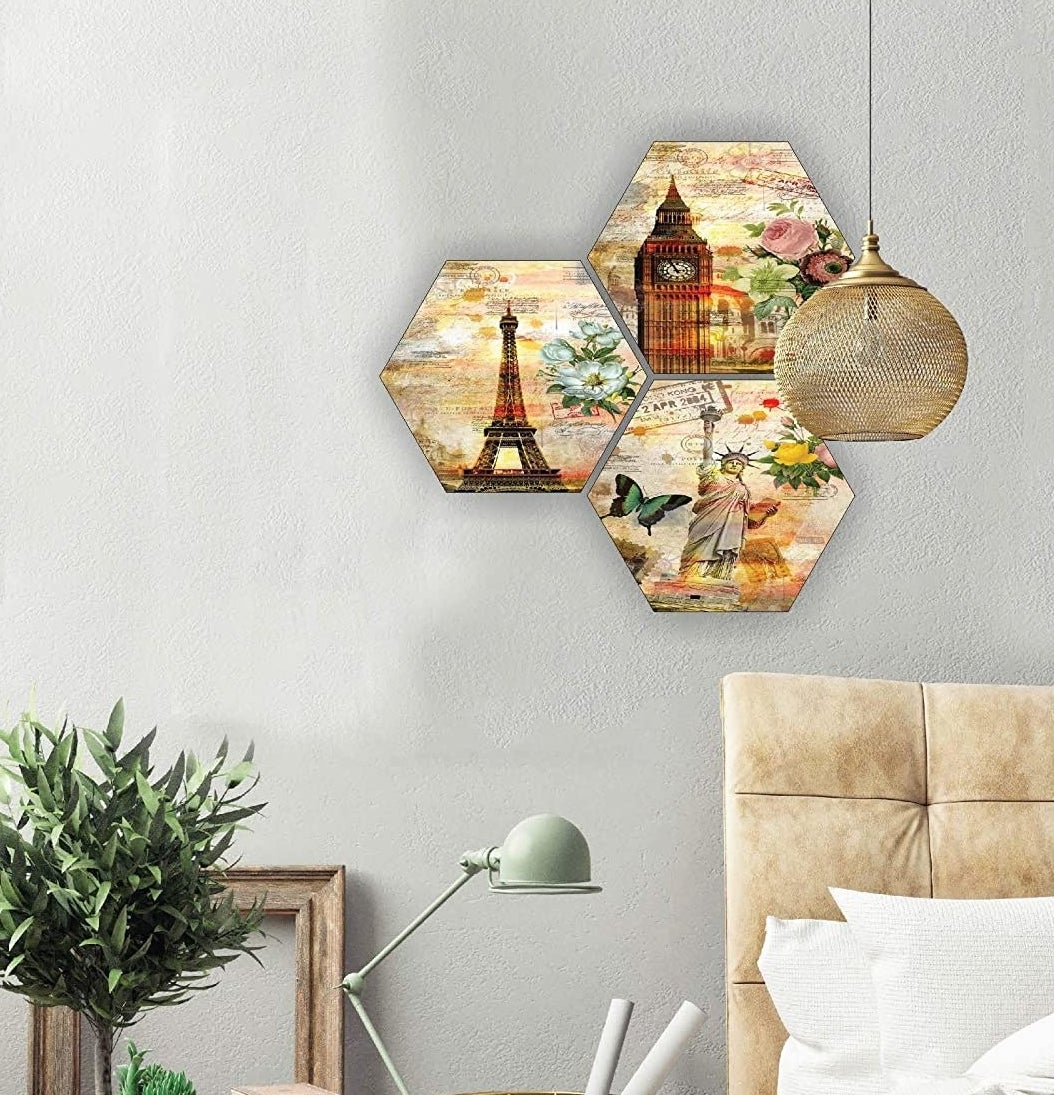 A set of 3 hexagonal paintings of the Eiffel Tower, Statue of Liberty and The Big Ben