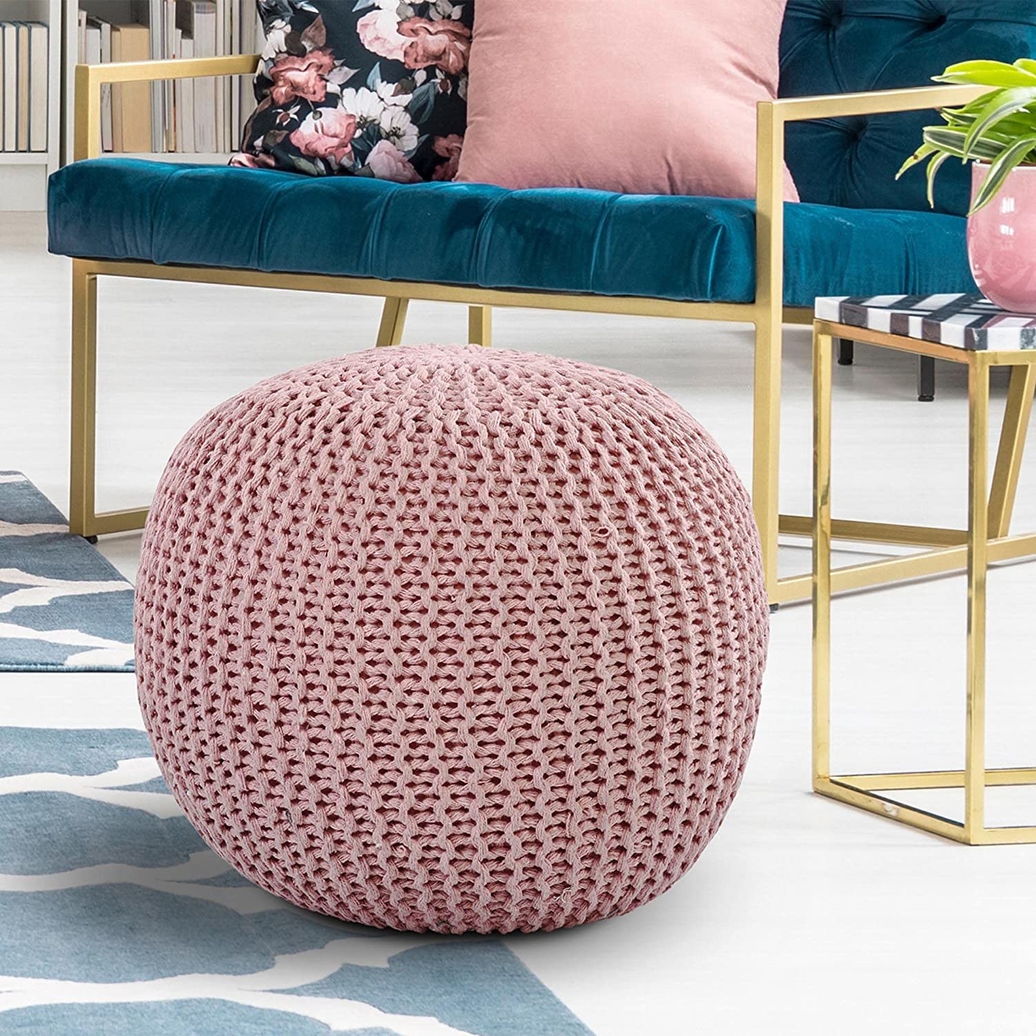 A knitted round pouffe in a baby pink shade