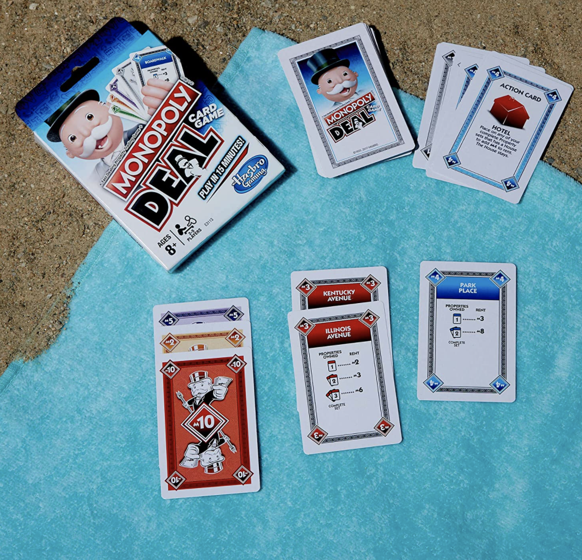 Monopoly card game on beach towel
