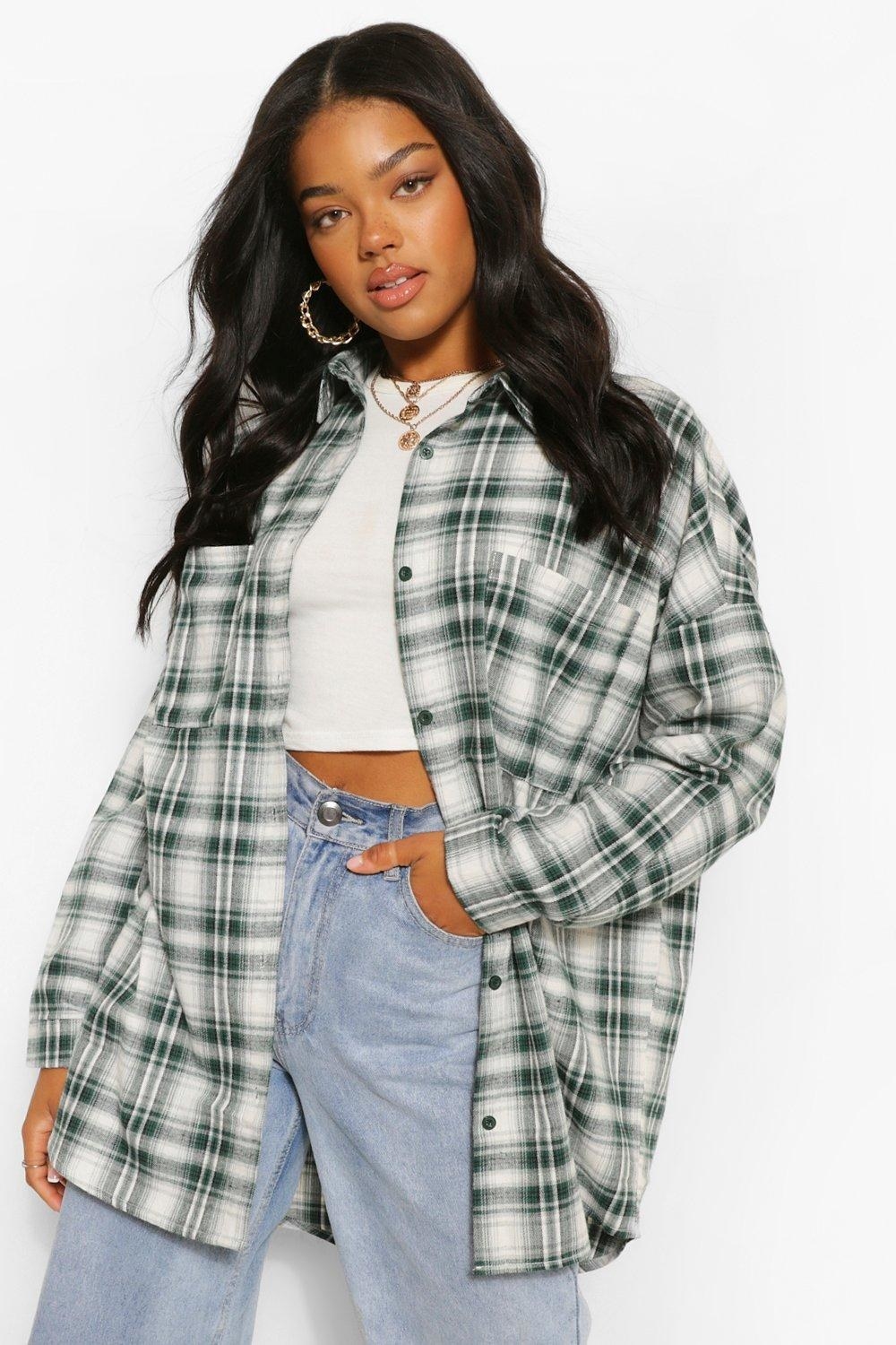a model in an oversized green and white flannel