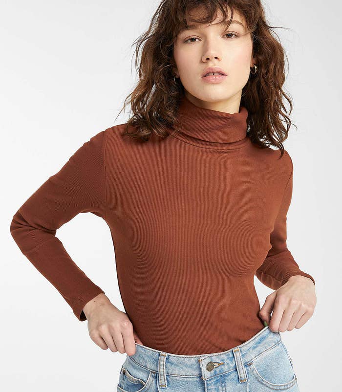 a person wearing the fitted turtleneck with a pair of jeans