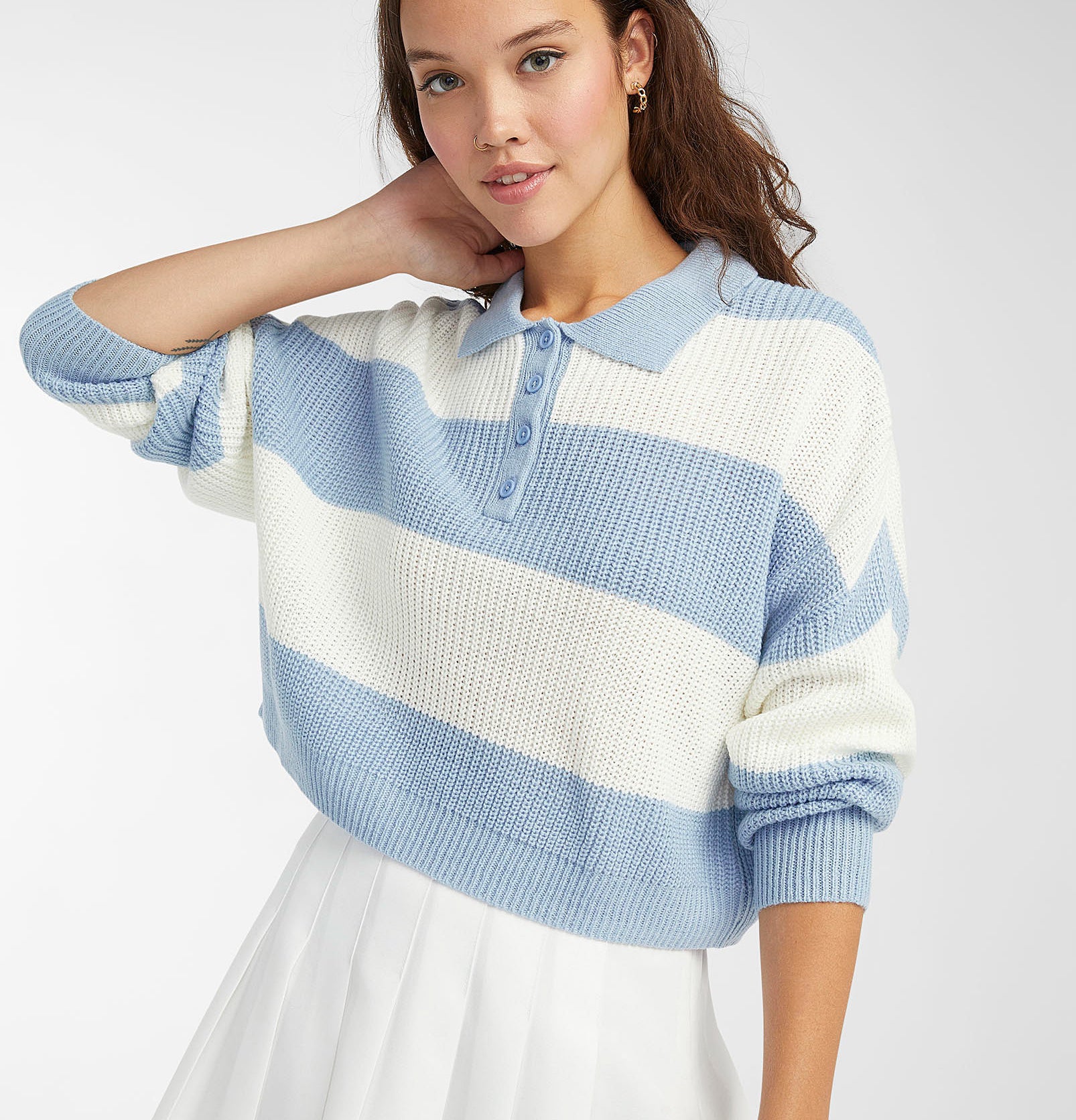 a person wearing the striped polo sweater with a skirt