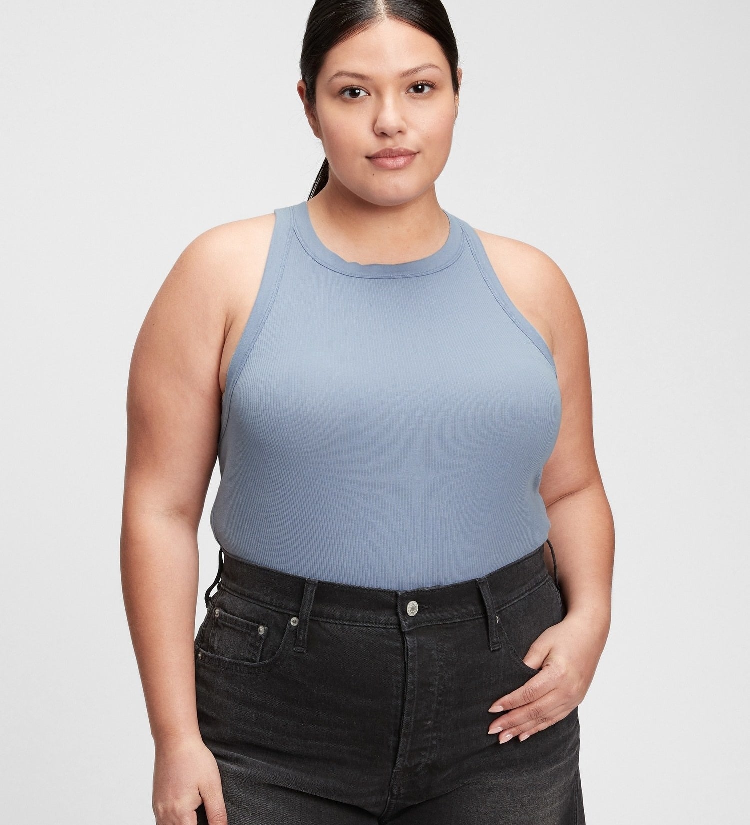 a person wearing the tank with a pair of jeans