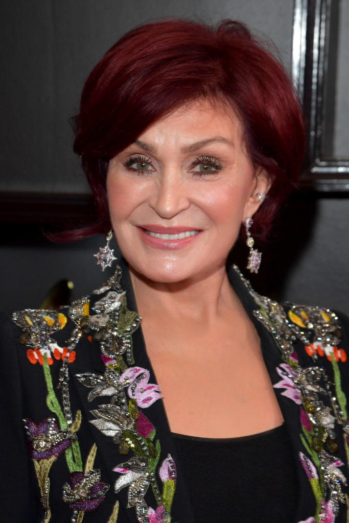 A smiling Sharon Osbourne with a brightly decorated jacket