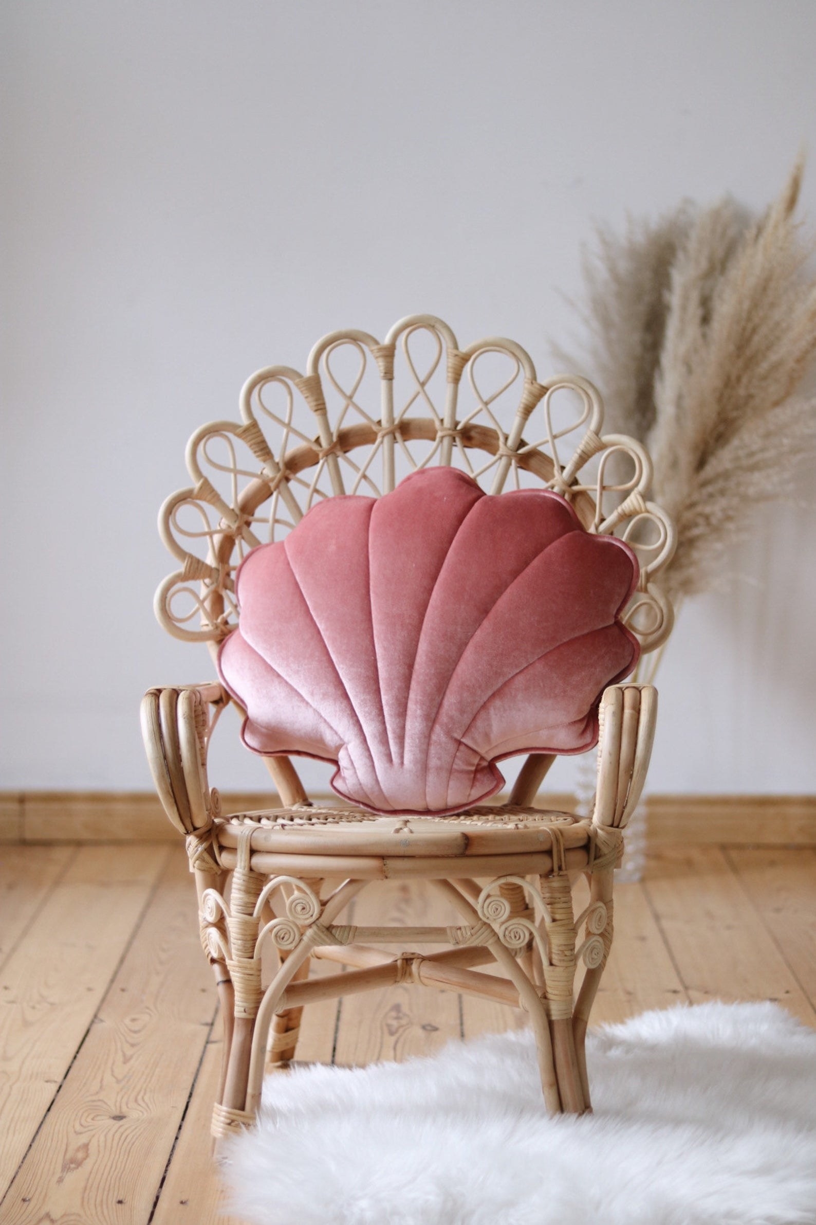 pillow shaped like a shell in a pink fabric
