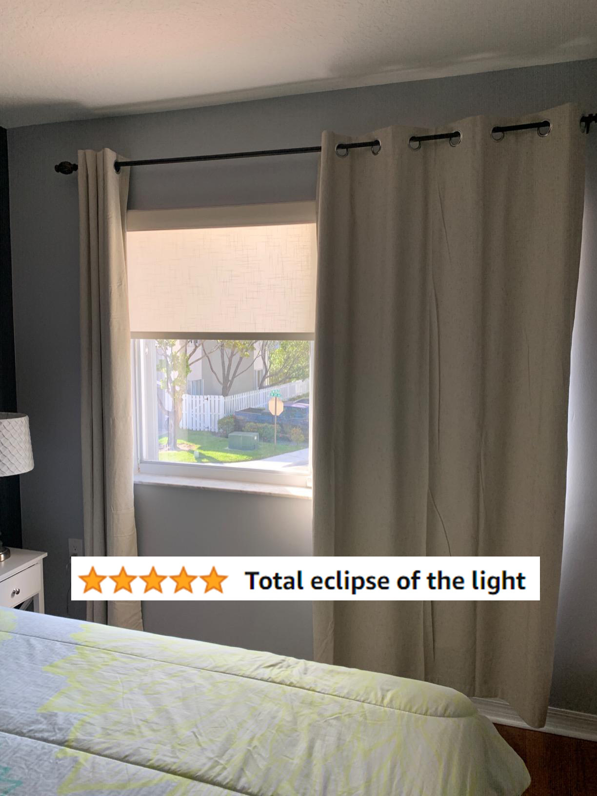 tan curtains blocking lots of light from a reviewer&#x27;s window, with the text &quot;total eclipse of the light&quot;