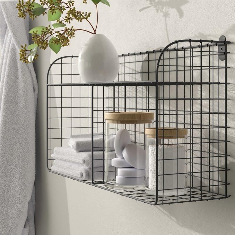 Black wire shelf with bathroom accessories hanging on the wall