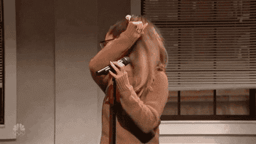 A gif of Ariana Grande on SNL holding up her hand