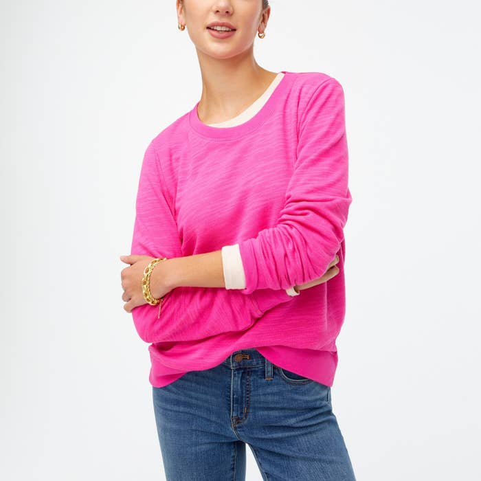 Model wearing the neon flamingo cotton terry crewneck sweatshirt