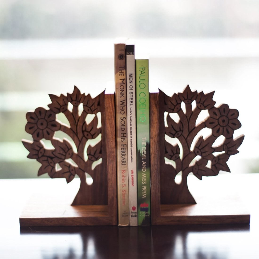 Two tree shaped bookends with books between them